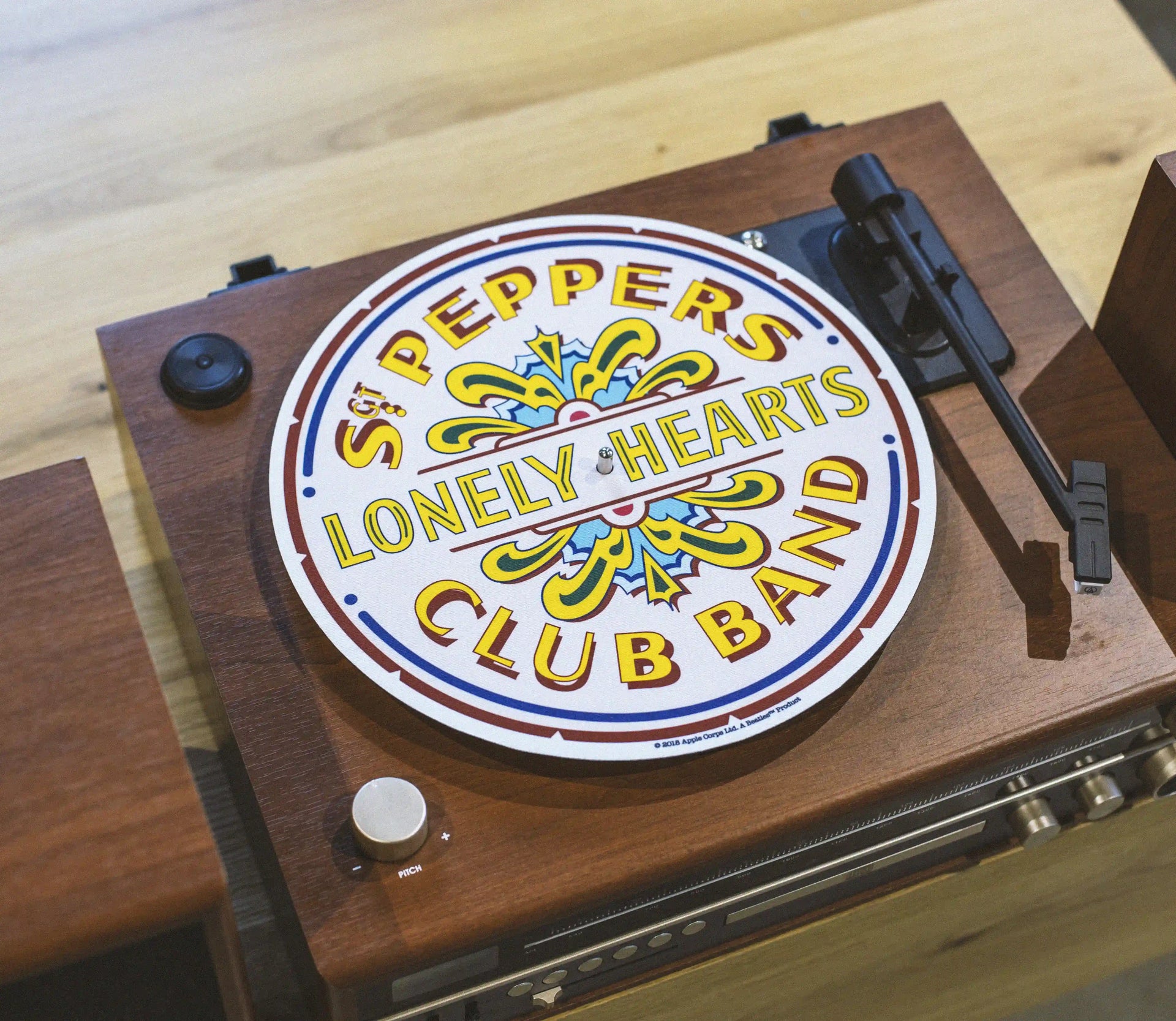 Crosley Beatles Sgt Pepper white slip mat displayed in lifestyle setting for vinyl record player
