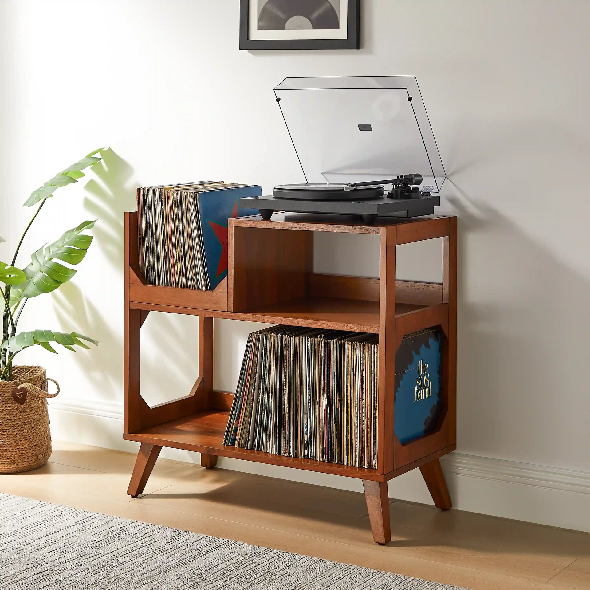 Crosley Asheville walnut record player stand with vinyl storage in a home entertainment setting