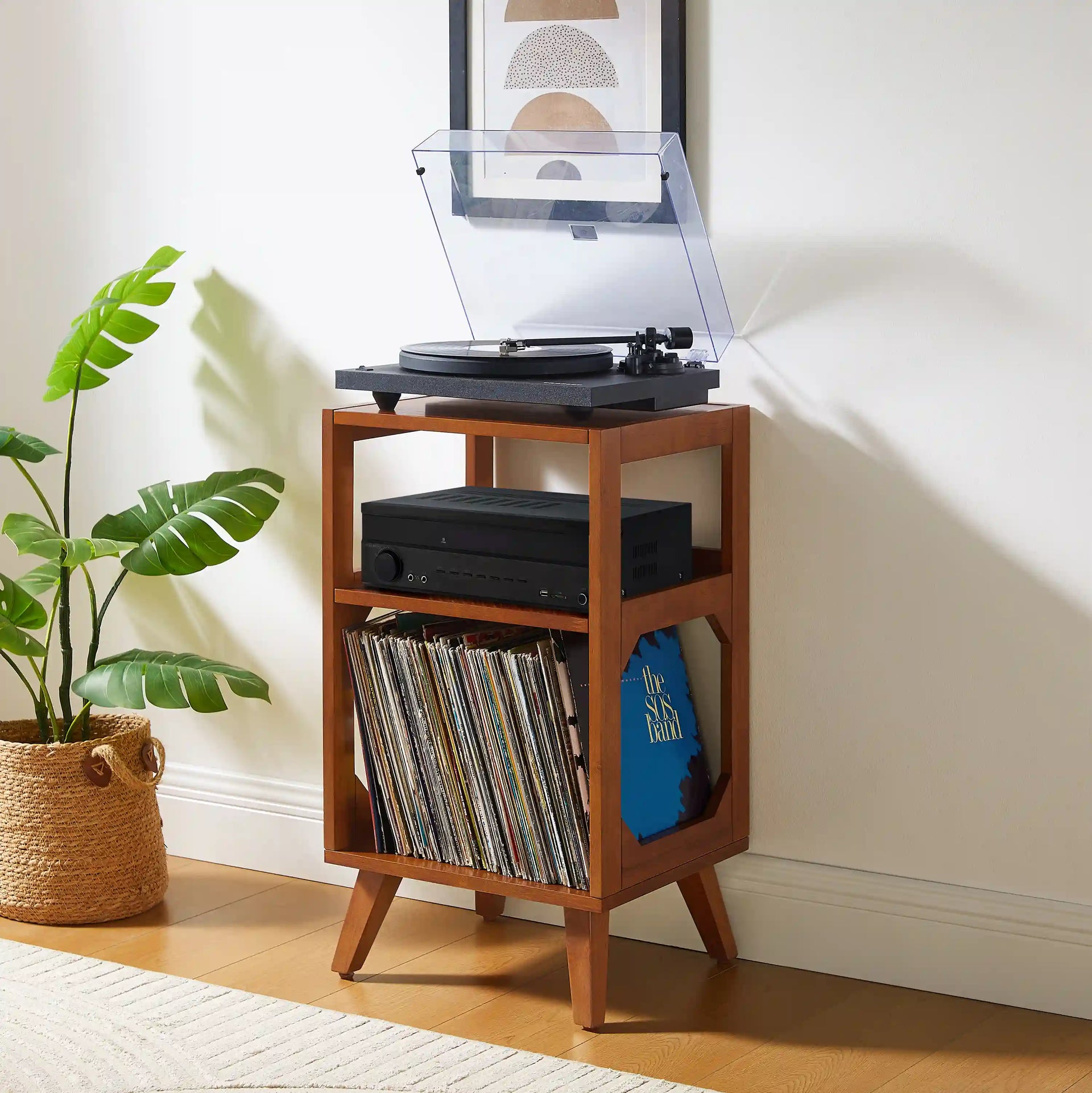 Crosley Asheville walnut record player stand with vinyl storage displayed in a living room setting