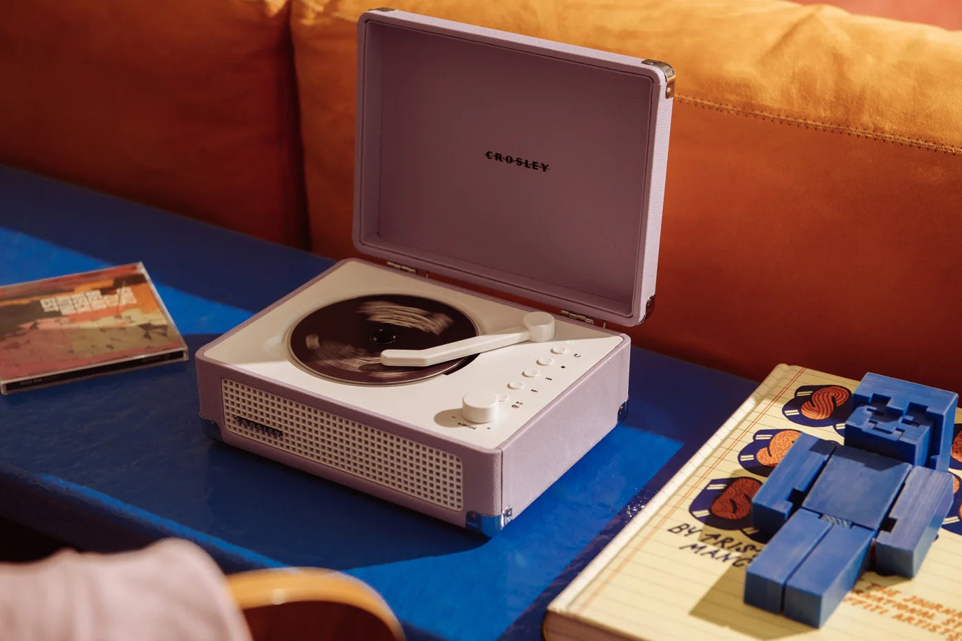 Lavender Crosley Cruiser CD player displayed in a lifestyle setting