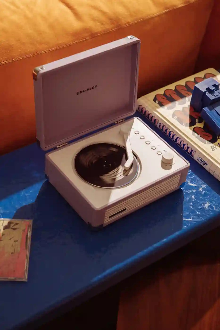Lavender Crosley Cruiser CD player displayed in a lifestyle setting