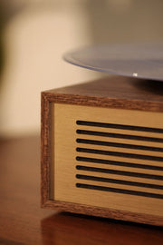 Crosley Miles Bluetooth record player in walnut finish, detail view showing wood grain texture