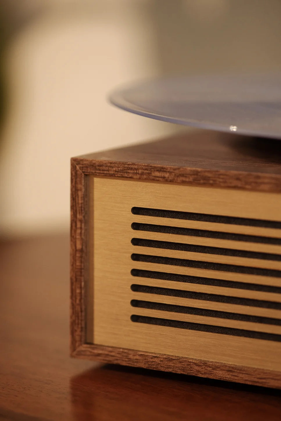 Crosley Miles Bluetooth record player in walnut finish, detail view showing wood grain texture