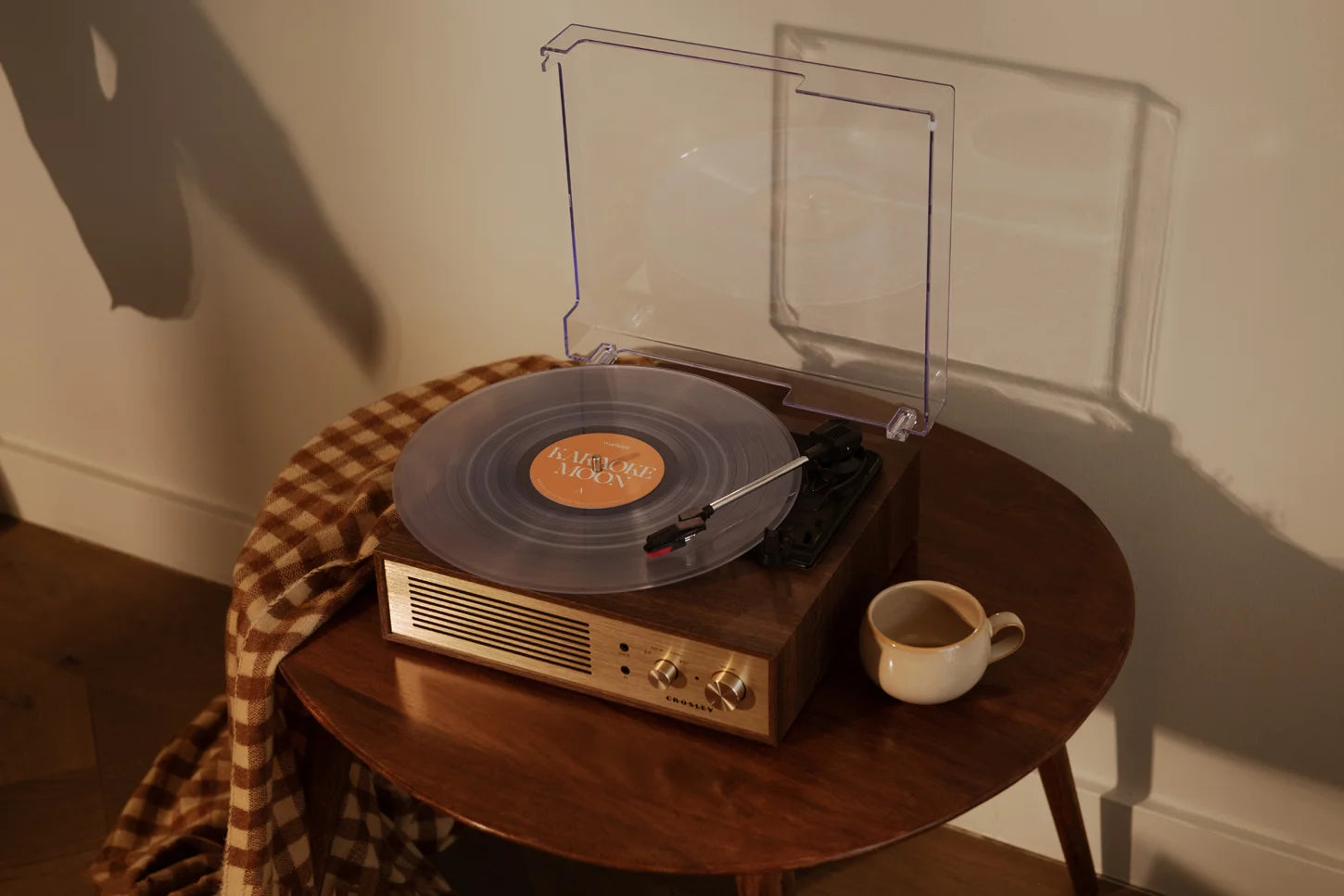 Crosley Miles Bluetooth record player in walnut finish displayed in a home setting