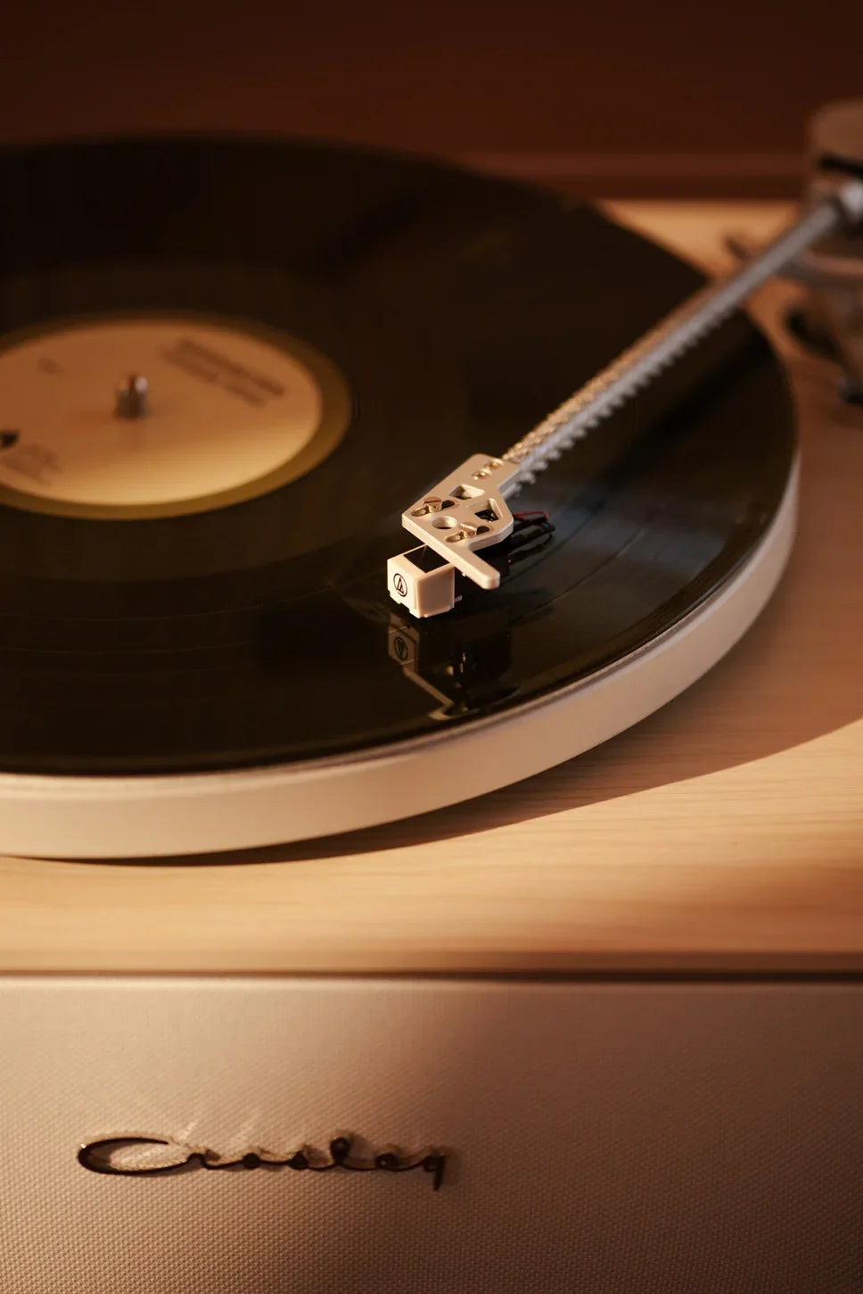 Crosley Stave Bluetooth Record Player in natural wood finish displayed in a lifestyle setting