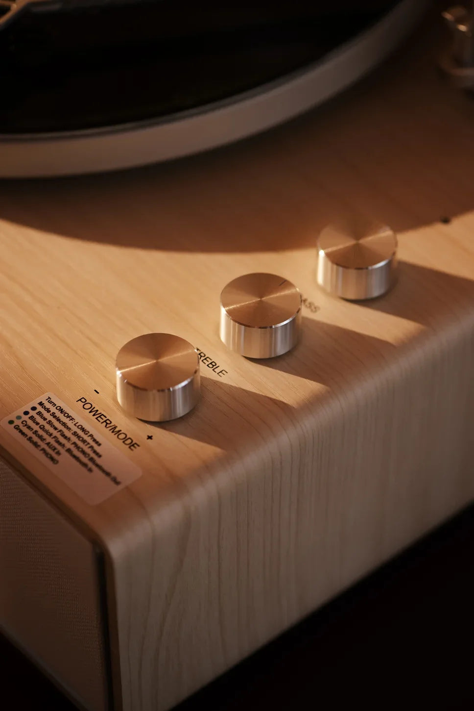 Crosley Stave Bluetooth Record Player in natural wood finish displayed in a lifestyle setting