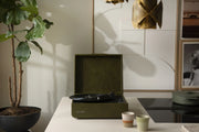 Crosley Mercury Bluetooth vinyl record player in forest green displayed in a home setting