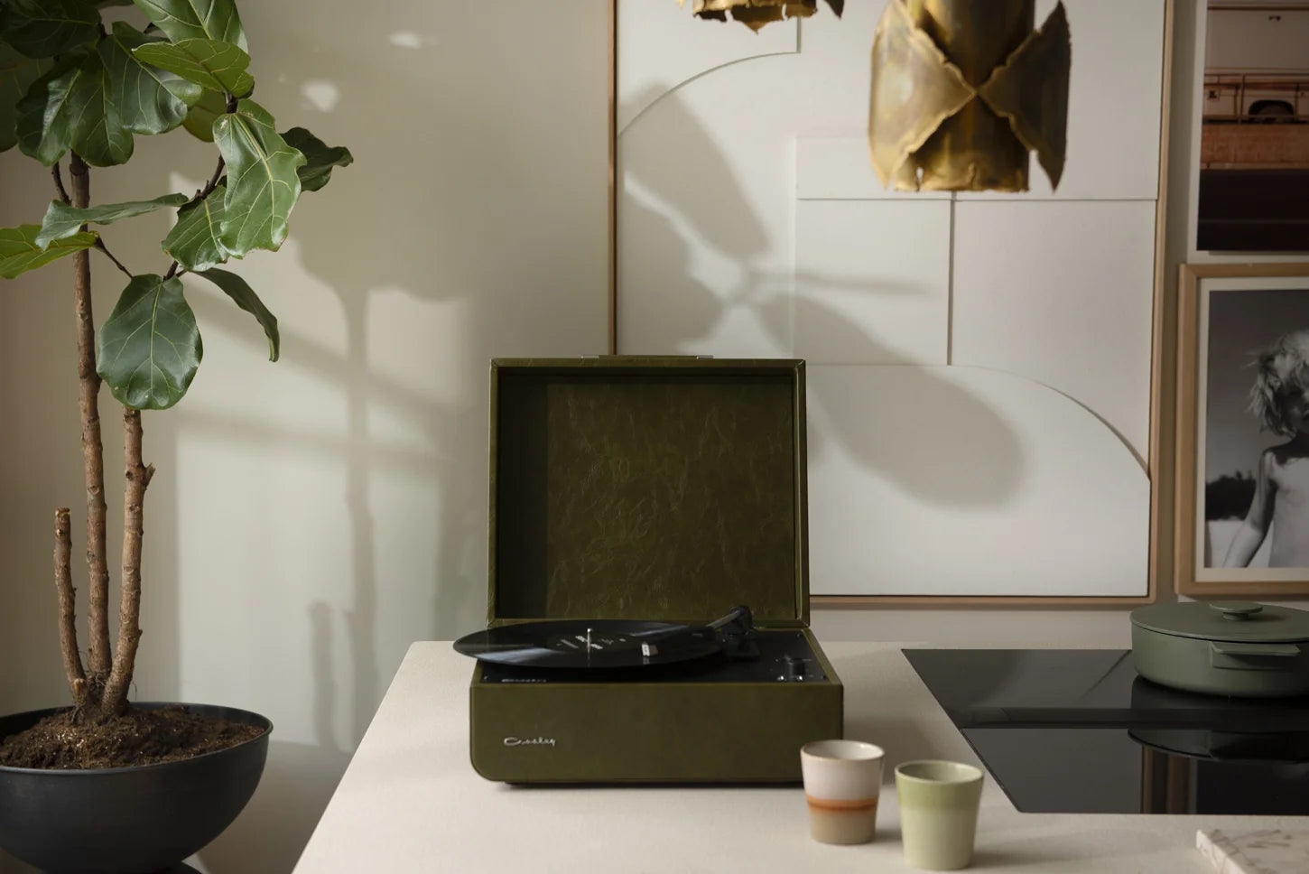 Crosley Mercury Bluetooth vinyl record player in forest green displayed in a home setting