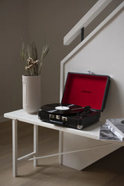 Crosley Cruiser Plus Bluetooth record player in black, displayed in a lifestyle setting