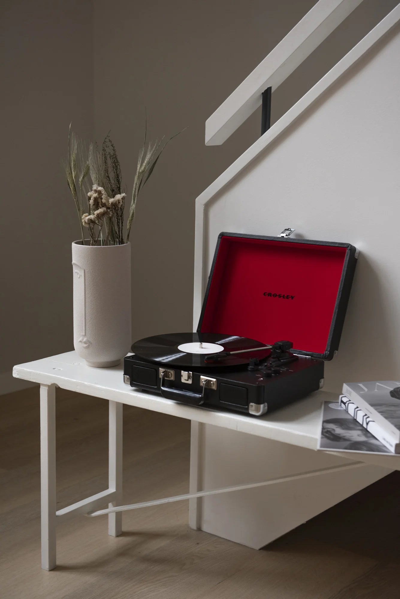 Crosley Cruiser Plus Bluetooth record player in black, displayed in a lifestyle setting