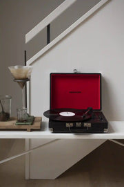 Crosley Cruiser Plus Bluetooth record player in black, displayed in a lifestyle setting