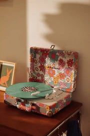 Crosley Cruiser Plus floral record player displayed in lifestyle setting with Bluetooth connectivity