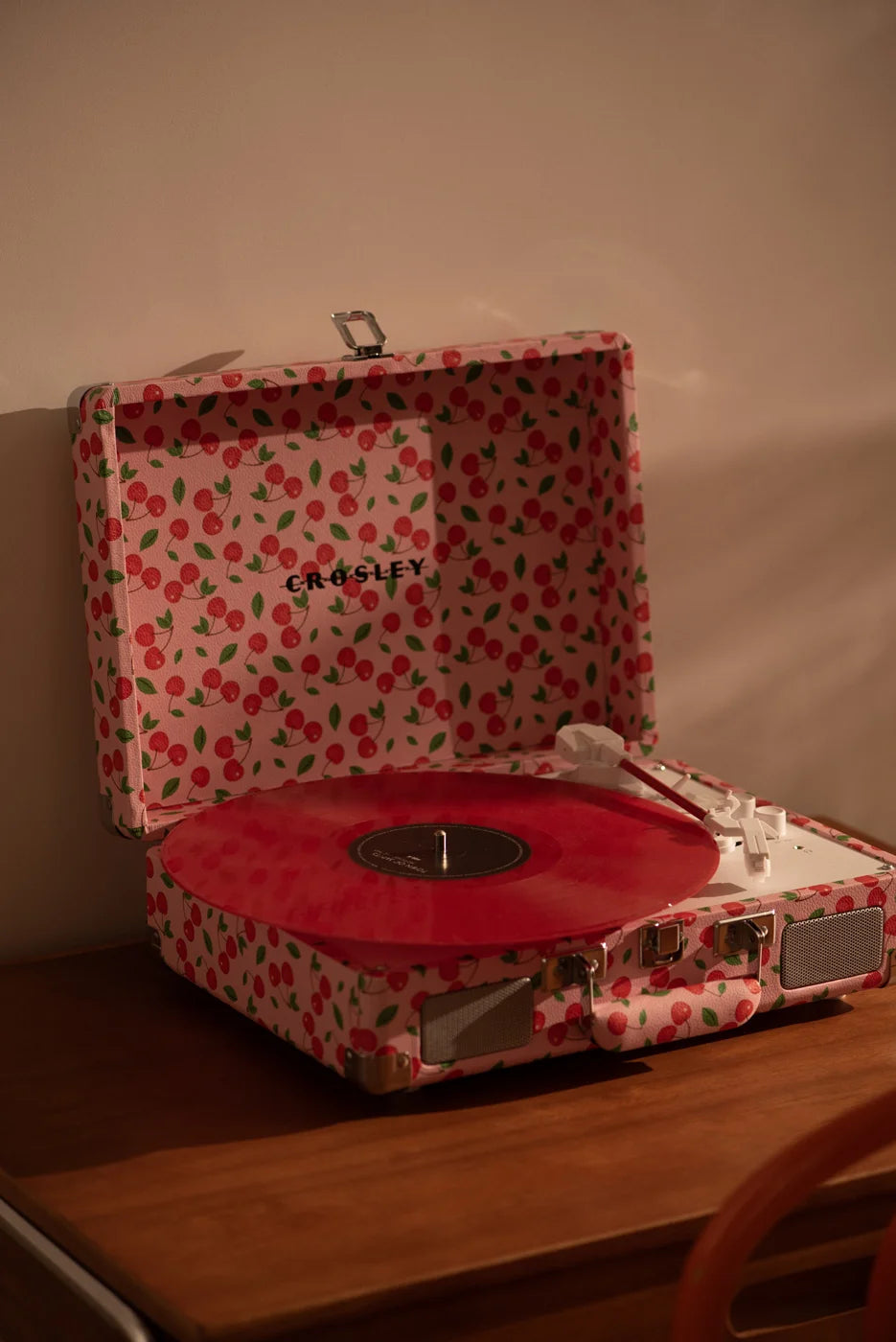 Red Crosley Cruiser Plus Bluetooth record player on display in a lifestyle setting