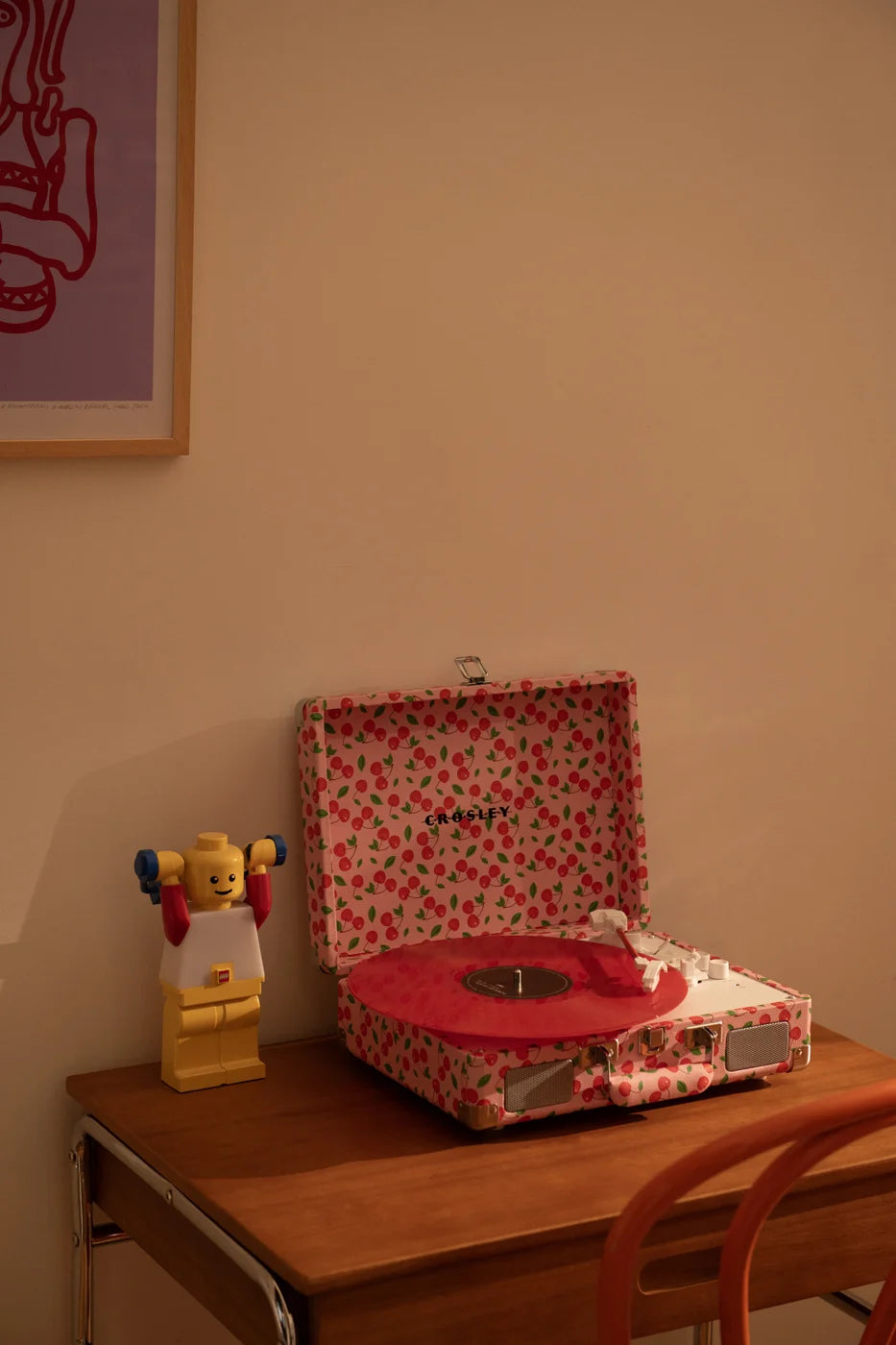 Red Crosley Cruiser Plus Bluetooth record player displayed in lifestyle setting