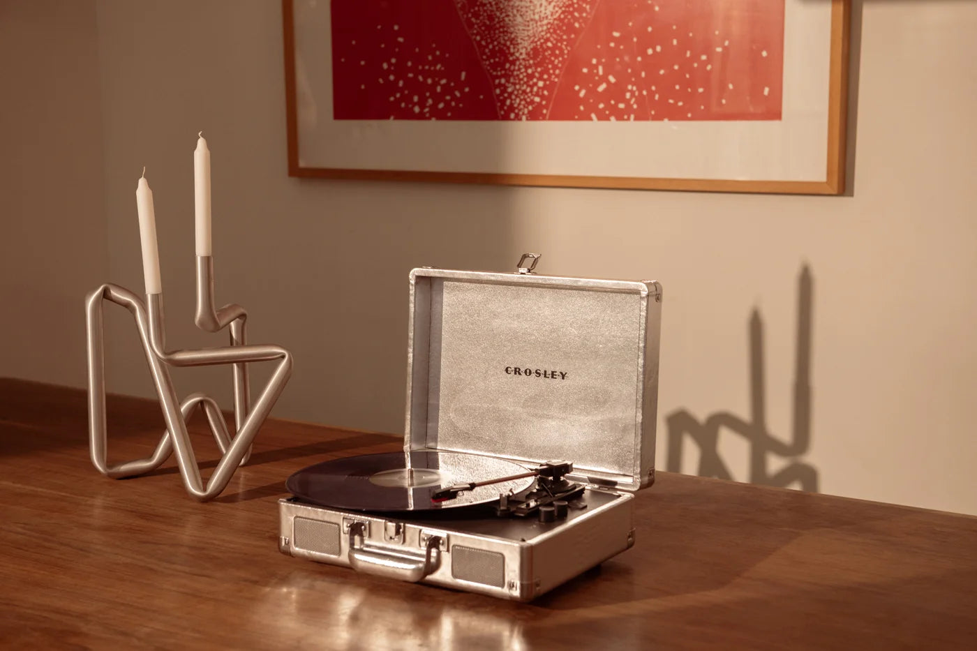 Crosley Cruiser Plus silver Bluetooth record player displayed in a lifestyle setting